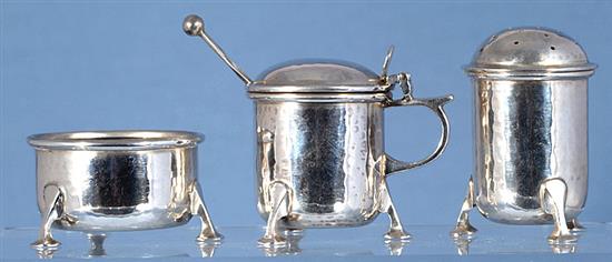 A George V Arts & Crafts silver three piece condiment set,